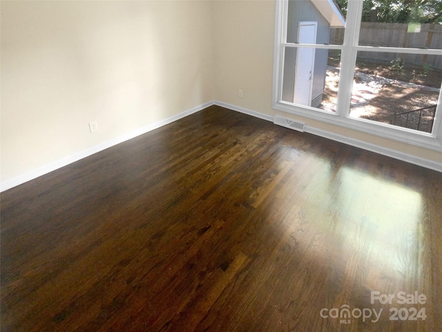 unfurnished room featuring dark hardwood / wood-style flooring