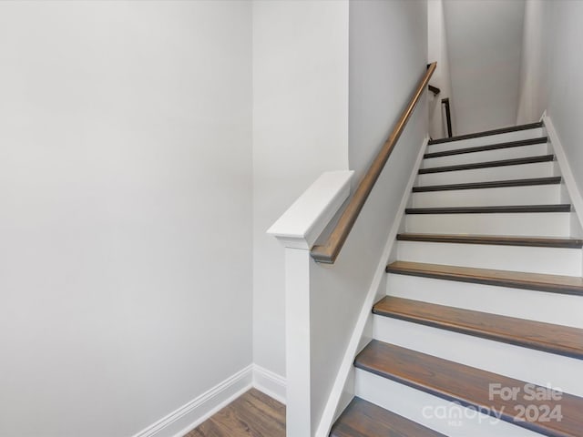 stairs with hardwood / wood-style floors