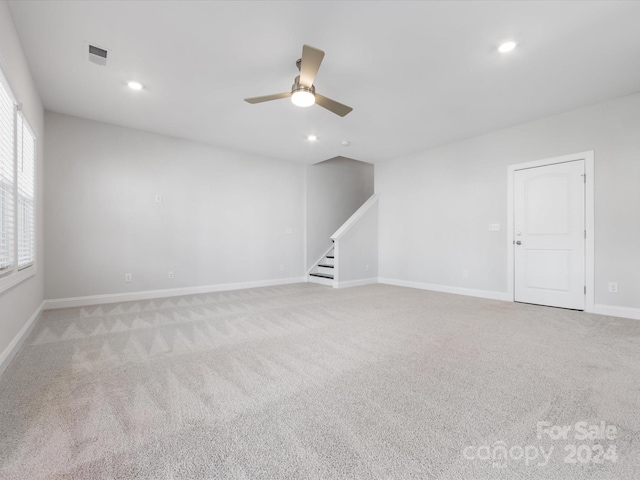 spare room featuring ceiling fan and light colored carpet