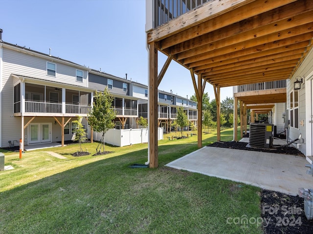 view of yard featuring central air condition unit and a patio area