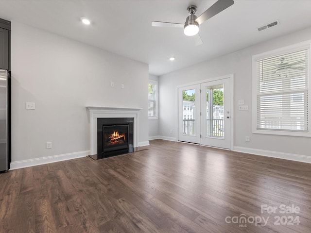 unfurnished living room with ceiling fan and dark hardwood / wood-style floors