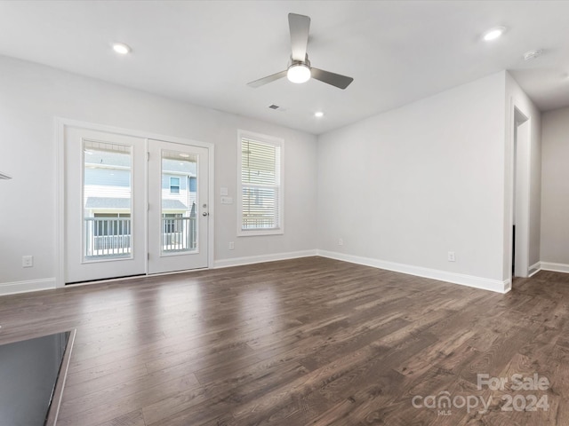 unfurnished living room featuring ceiling fan and dark wood-type flooring