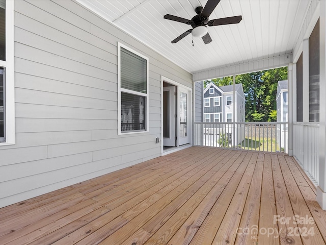 wooden deck featuring ceiling fan