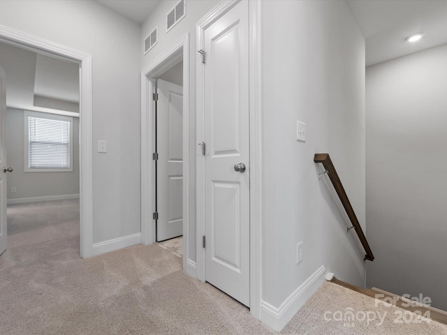 hallway with light carpet