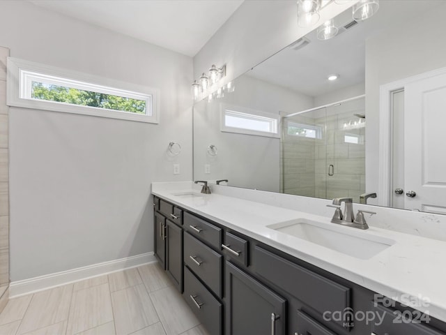 bathroom featuring vanity and an enclosed shower