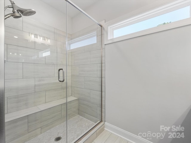 bathroom featuring ceiling fan and a shower with shower door