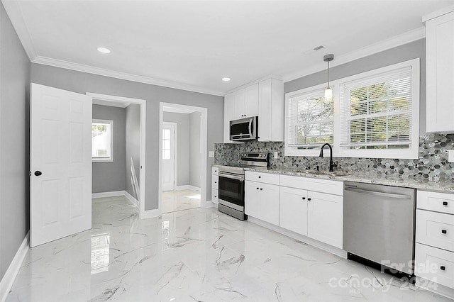 kitchen featuring white cabinetry, sink, light stone counters, backsplash, and appliances with stainless steel finishes