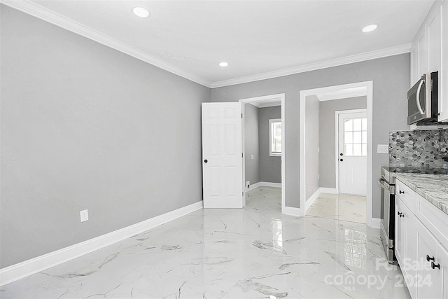 kitchen featuring decorative backsplash, light stone countertops, ornamental molding, appliances with stainless steel finishes, and white cabinetry