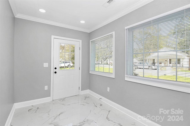 doorway with ornamental molding and a healthy amount of sunlight