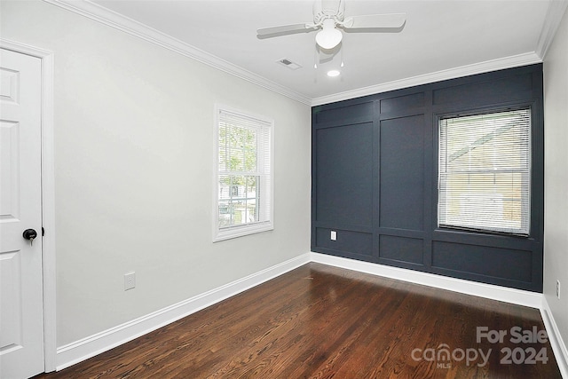 empty room featuring dark hardwood / wood-style flooring, ceiling fan, and crown molding