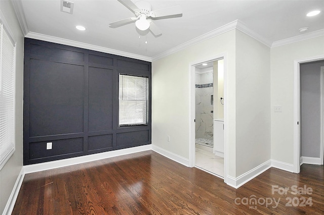 unfurnished bedroom featuring ornamental molding, ceiling fan, dark wood-type flooring, connected bathroom, and a closet