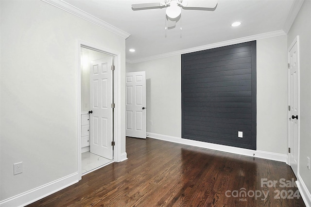 empty room with dark hardwood / wood-style floors, ceiling fan, and ornamental molding