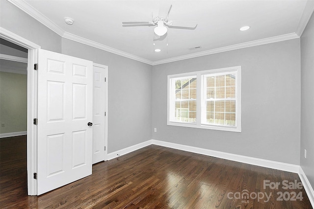 unfurnished bedroom with a closet, dark hardwood / wood-style floors, ceiling fan, and ornamental molding