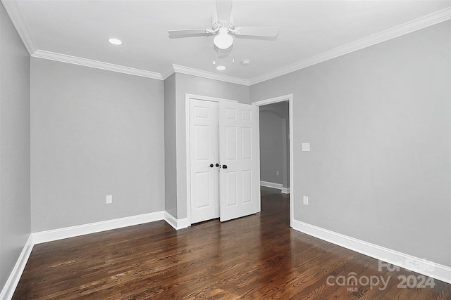 unfurnished bedroom with dark hardwood / wood-style floors, ceiling fan, and crown molding