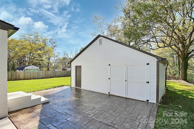 view of outbuilding with a lawn