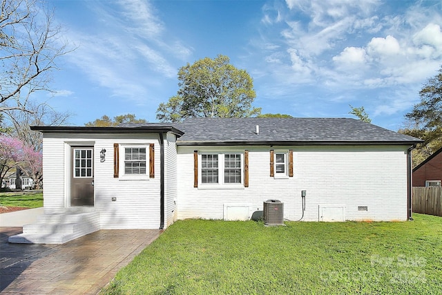 back of house with central air condition unit, a yard, and a patio