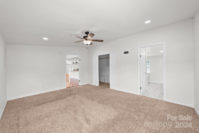 unfurnished room with light carpet and ceiling fan