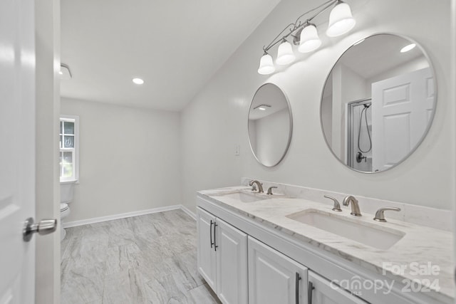 bathroom featuring vanity, toilet, and walk in shower