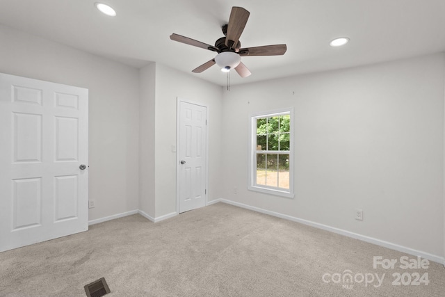 unfurnished bedroom featuring ceiling fan and light colored carpet