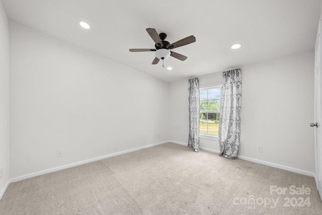 unfurnished room featuring ceiling fan and light colored carpet