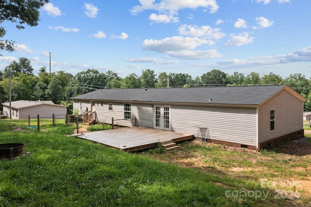 back of property featuring french doors, a lawn, and a wooden deck