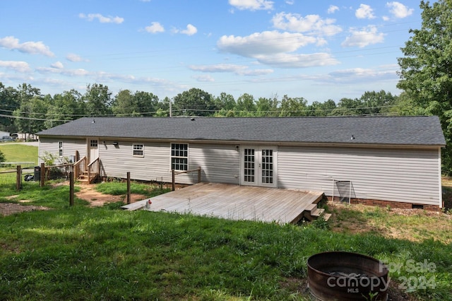 rear view of house with a yard and a wooden deck