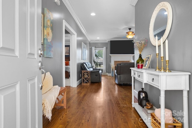 entrance foyer with dark hardwood / wood-style flooring, ceiling fan, and ornamental molding