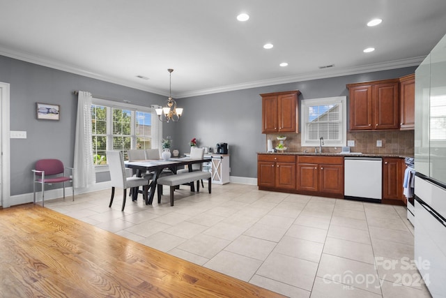 kitchen with white appliances, sink, decorative backsplash, ornamental molding, and light tile patterned flooring