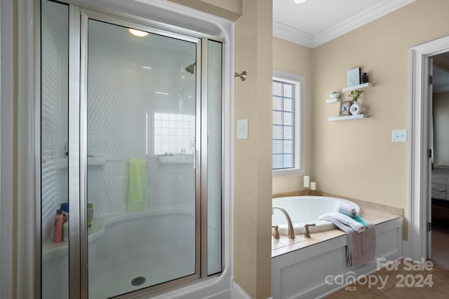 bathroom with tile patterned floors, crown molding, and shower with separate bathtub