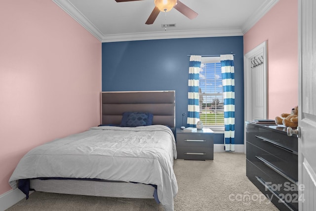 bedroom with ceiling fan, carpet, and ornamental molding