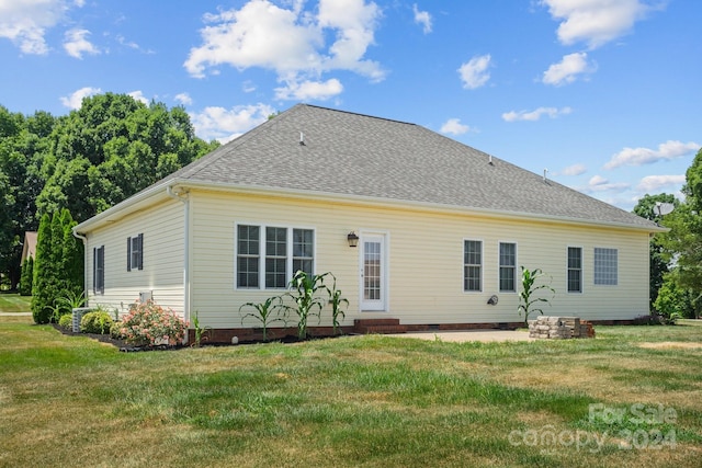 rear view of house with a lawn