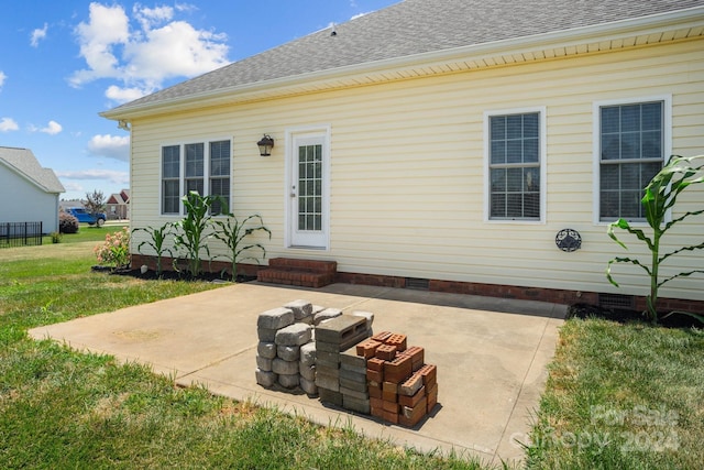 back of property featuring a yard and a patio