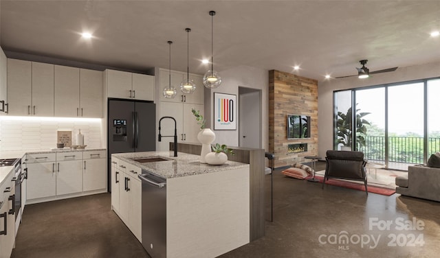 kitchen featuring sink, white cabinetry, stainless steel dishwasher, and an island with sink