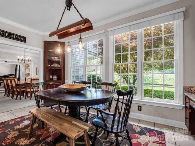 tiled dining room with a chandelier and crown molding