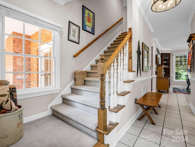 stairs with tile patterned floors and ornamental molding