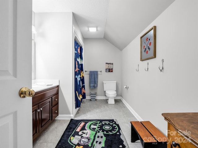 bathroom with toilet, vanity, vaulted ceiling, and a textured ceiling