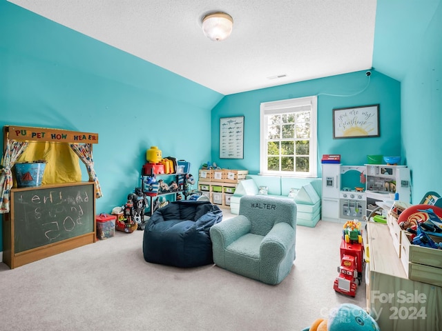 playroom with carpet floors, a textured ceiling, and vaulted ceiling