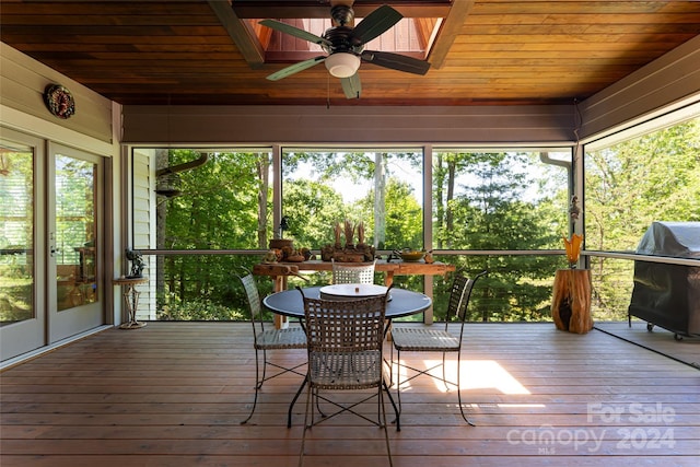 sunroom / solarium featuring ceiling fan and a healthy amount of sunlight