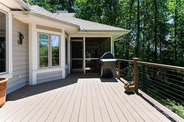 wooden terrace featuring area for grilling and a sunroom