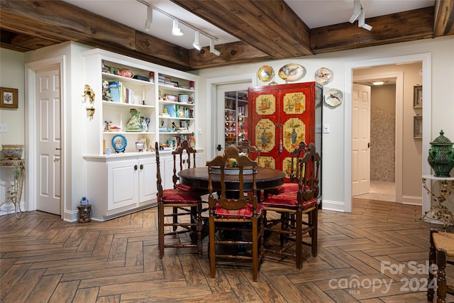 dining area with dark parquet floors and rail lighting