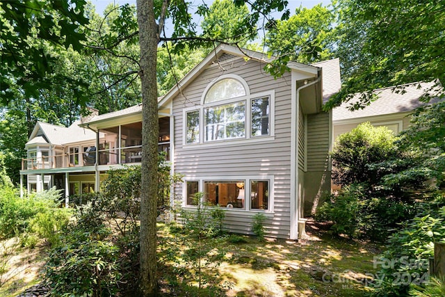 back of house featuring a sunroom