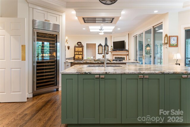 57 Old Hickory Trl, Hendersonville, NC 28739 - kitchen with green cabinets, beverage cooler, crown molding, dark wood-style flooring, and open floor plan