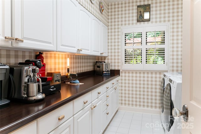 57 Old Hickory Trl, Hendersonville, NC 28739 - kitchen with wallpapered walls, separate washer and dryer, dark countertops, light tile patterned floors, and white cabinetry