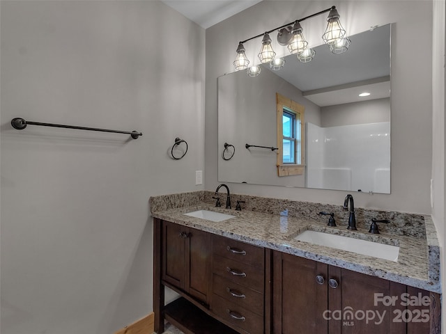 full bath featuring double vanity and a sink