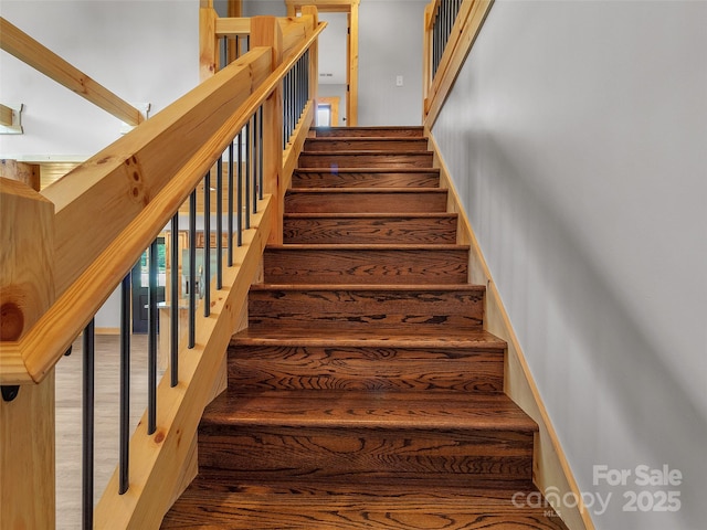 staircase featuring wood finished floors