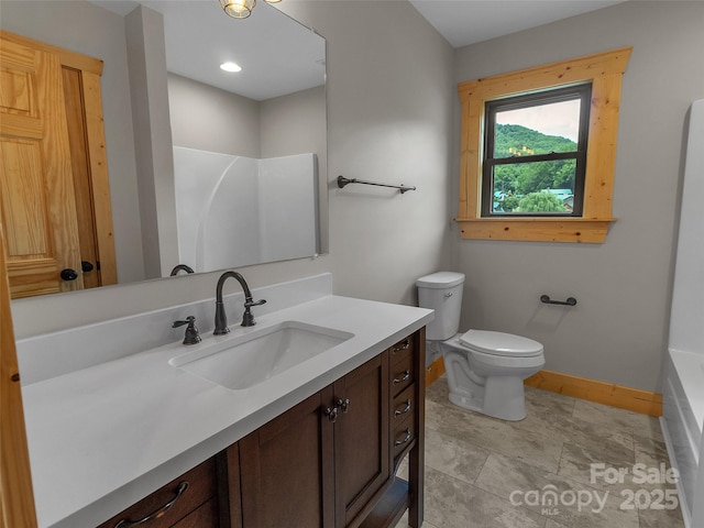 bathroom with baseboards, toilet, a shower, a tub to relax in, and vanity