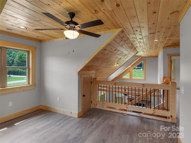 additional living space featuring baseboards, a ceiling fan, wood ceiling, vaulted ceiling, and wood finished floors