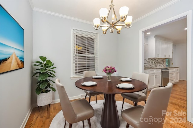 dining space featuring light hardwood / wood-style floors, crown molding, and a notable chandelier