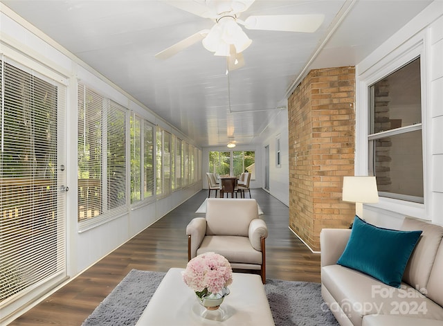 sunroom / solarium featuring ceiling fan