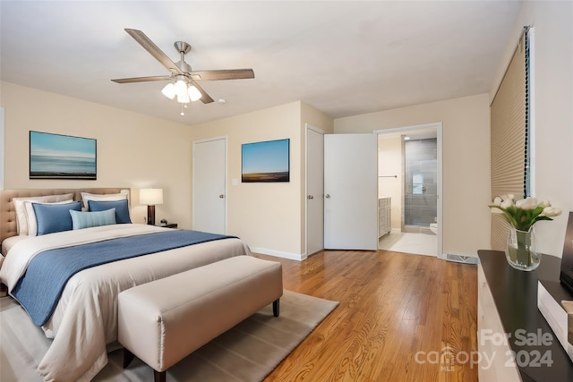 bedroom with ceiling fan, connected bathroom, and light hardwood / wood-style flooring